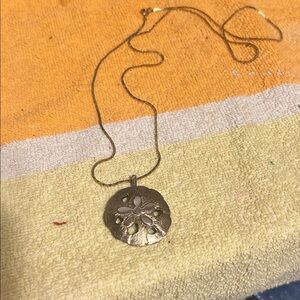 Vintage gold tone, sand dollar sun with a name on back with chain gold chain